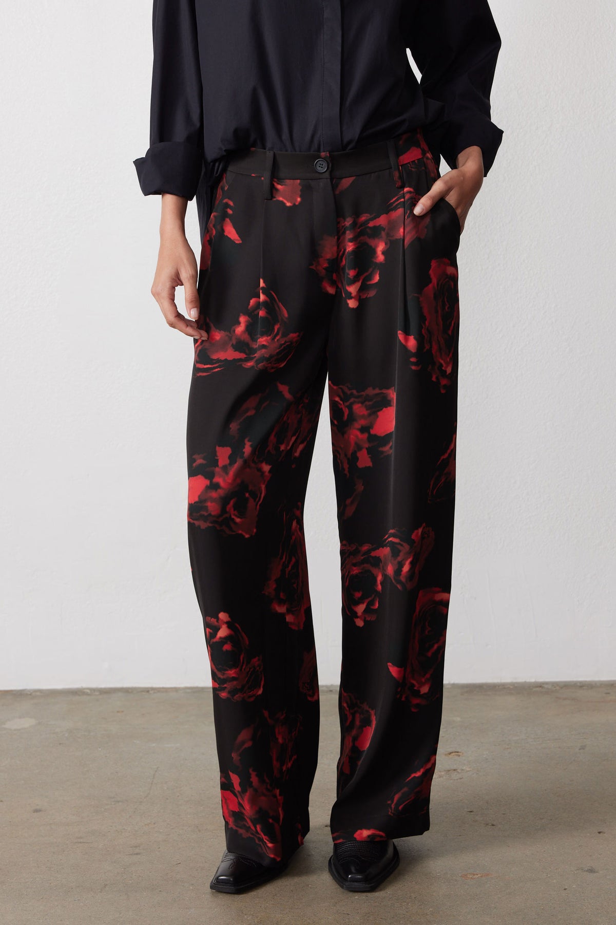 Wide-leg pants with black-and-red floral print, relaxed wide silhouette