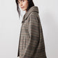 Brown plaid asymmetric collared jacket shown from the side