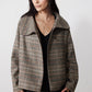 Brown plaid asymmetric collared jacket over black top, open front