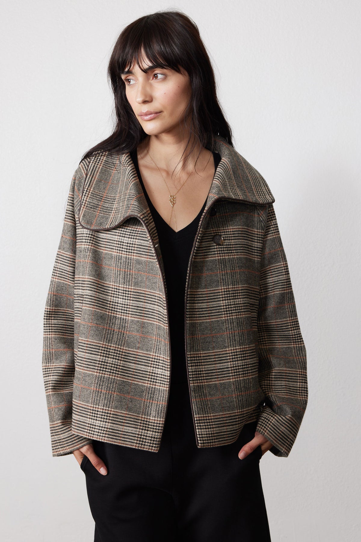 Brown plaid asymmetric collared jacket over black top, open front