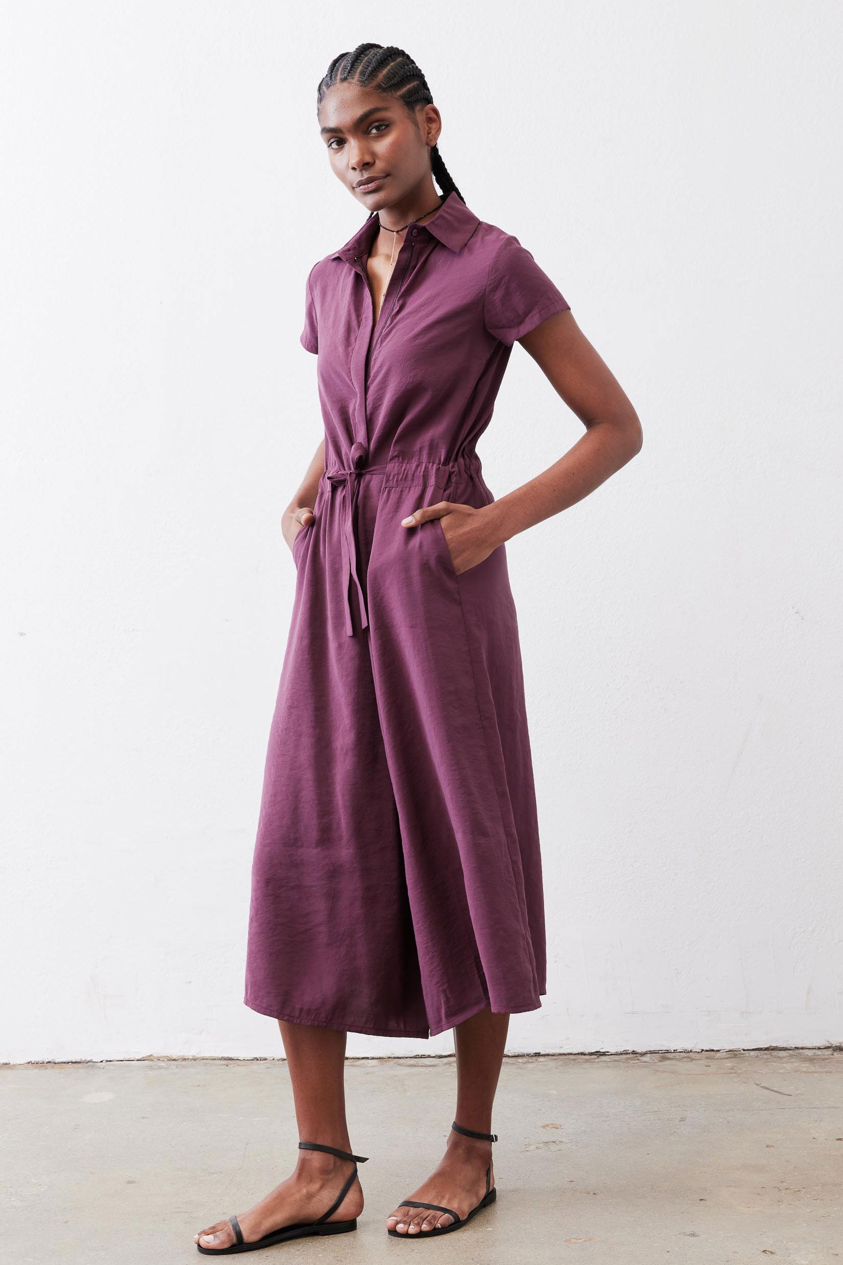 Maroon cropped jumpsuit with short sleeves, V-neck, and waist drawstring