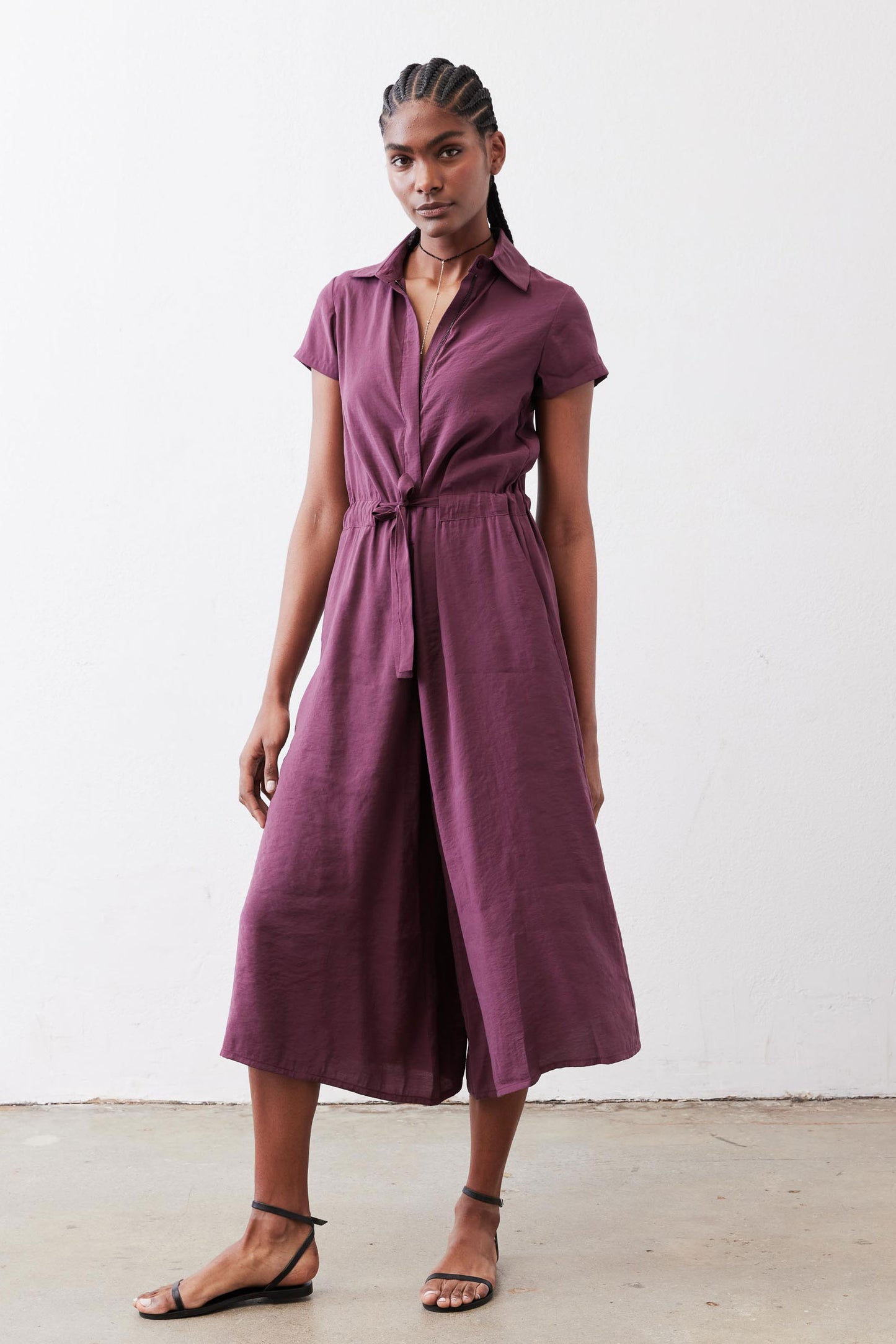 Maroon cropped wrap-style jumpsuit with belt tie and wide cropped legs