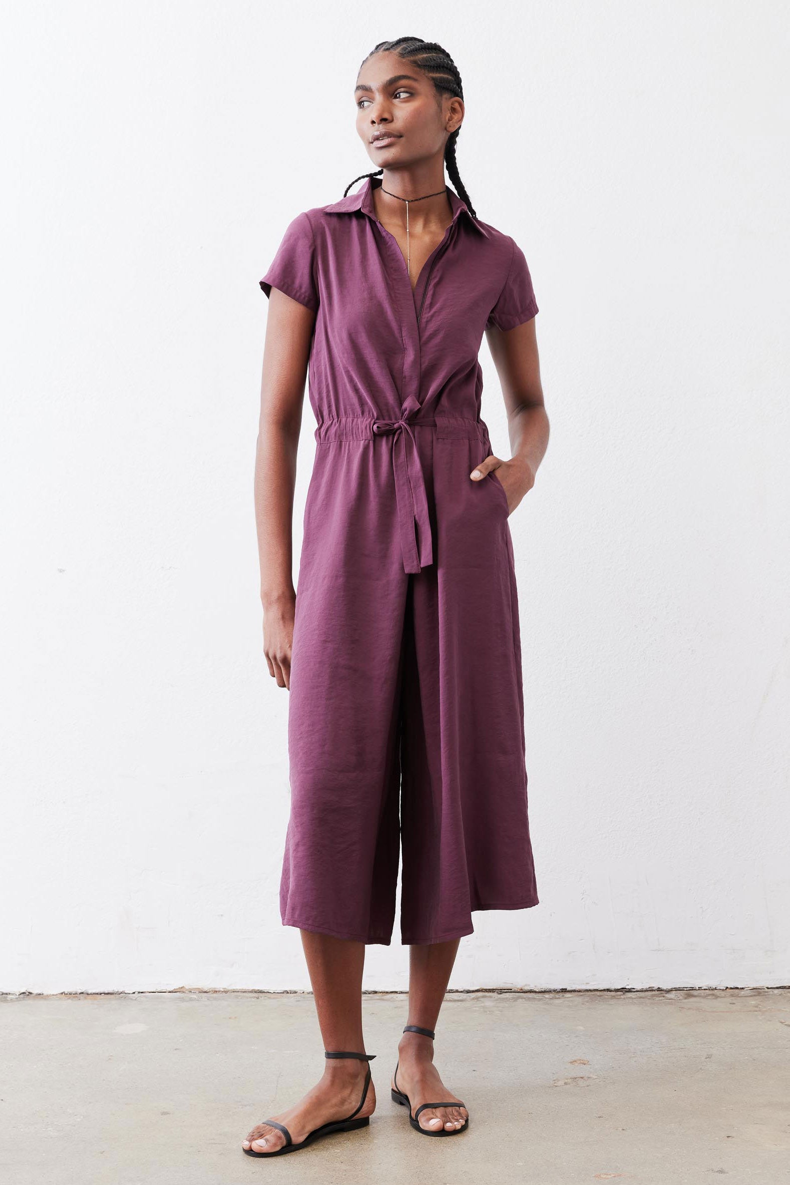 Maroon cropped jumpsuit with short sleeves, V-neck, and tied waist, front view