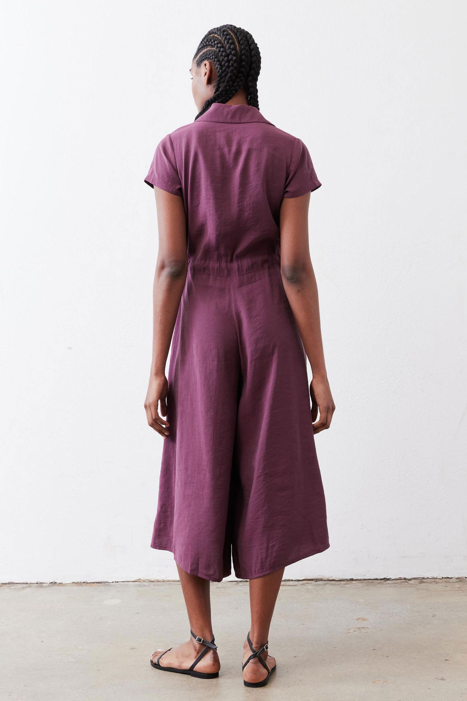 Maroon cropped jumpsuit with short sleeves and center back seam