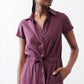 Maroon short-sleeve V-neck jumpsuit with drawstring waist and side pockets