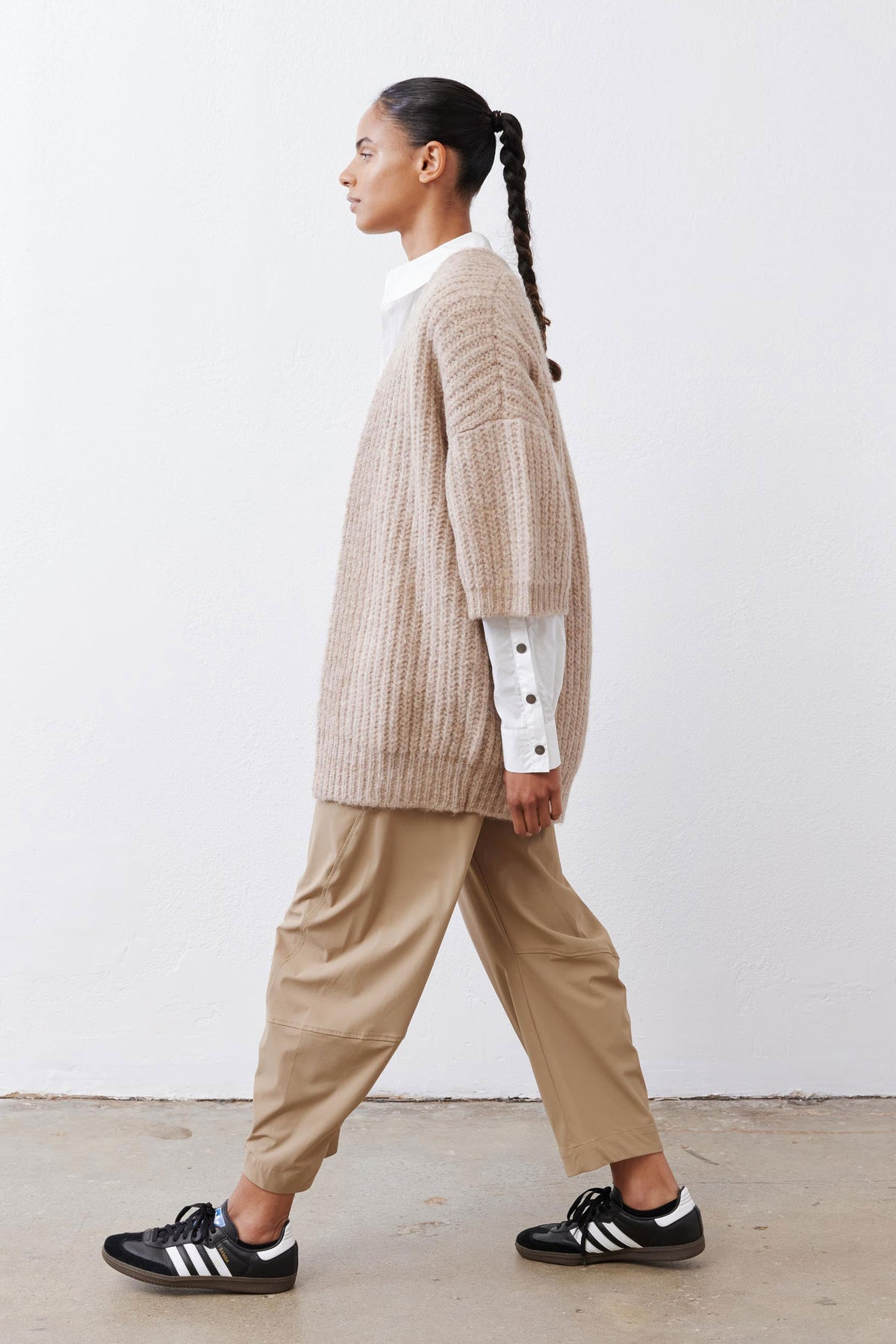 Side view of oatmeal knit kimono cardigan with wide sleeves and buttoned cuffs