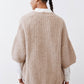 Back view of oatmeal knit kimono cardigan with textured yoke and wide kimono sleeves