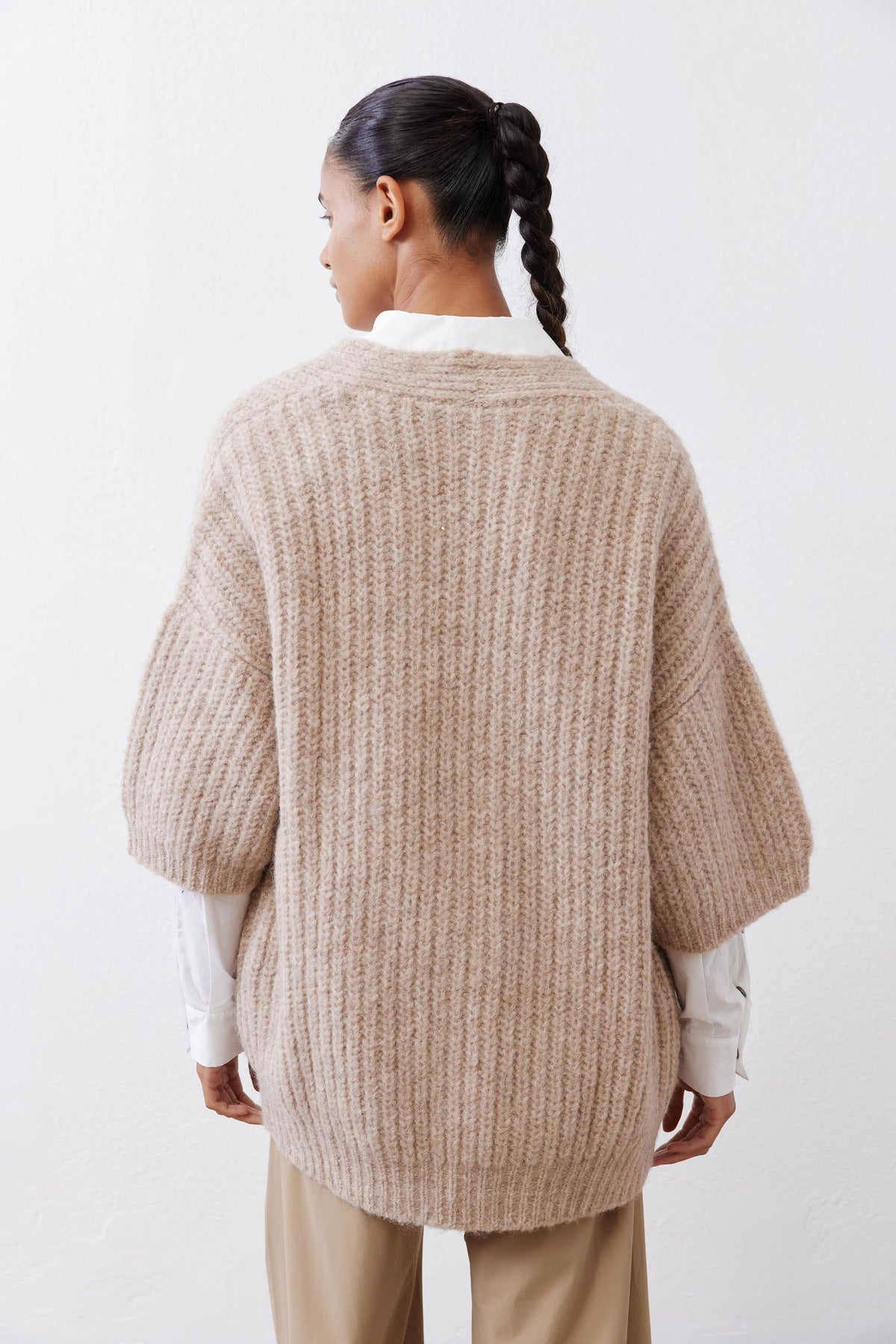 Back view of oatmeal knit kimono cardigan with textured yoke and wide kimono sleeves