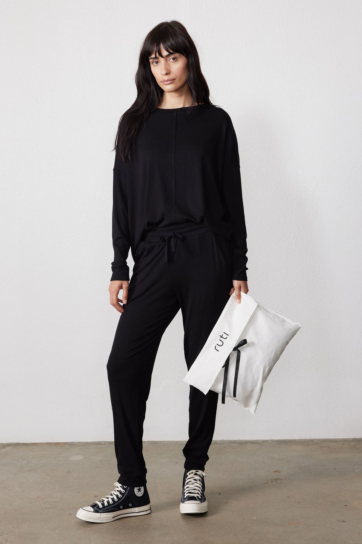 Black ribbed pajama set with a relaxed top and drawstring pants