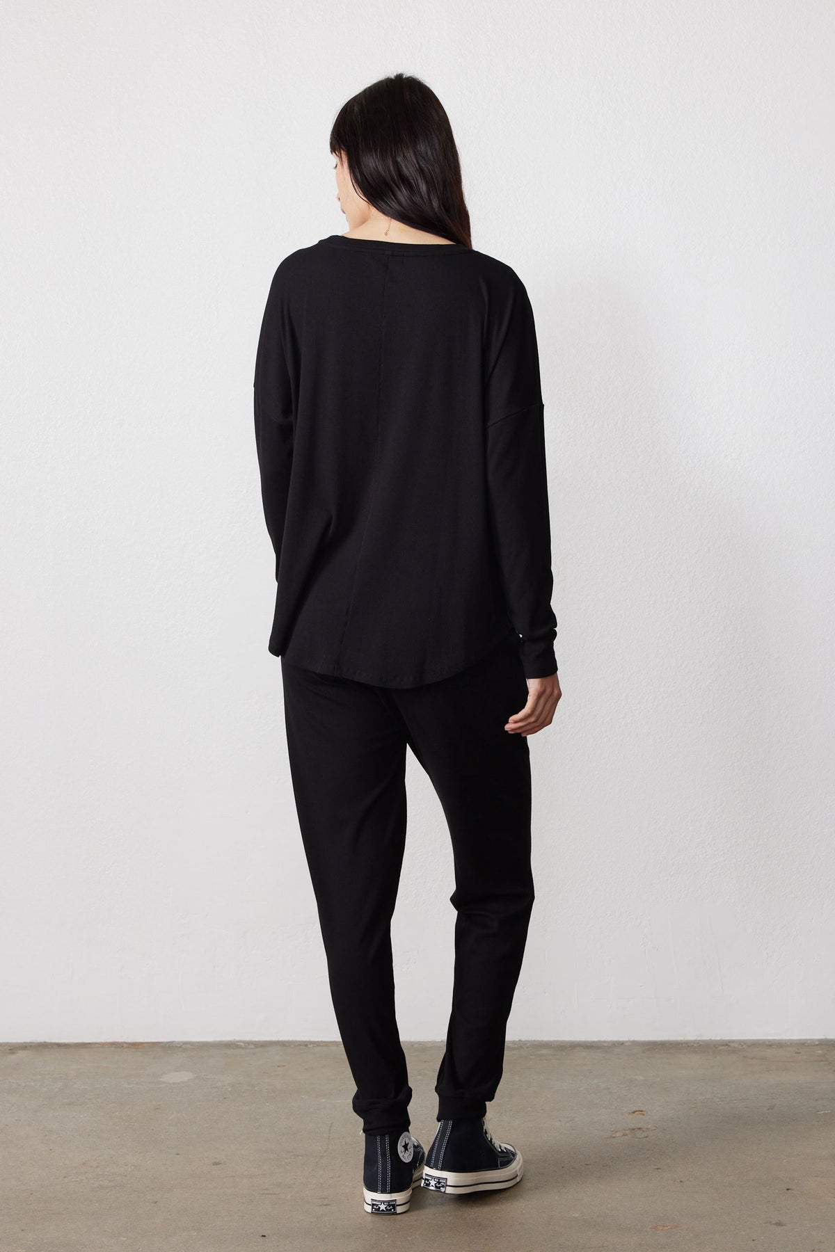 Back view of the black pajama set with a loose top and tapered pants