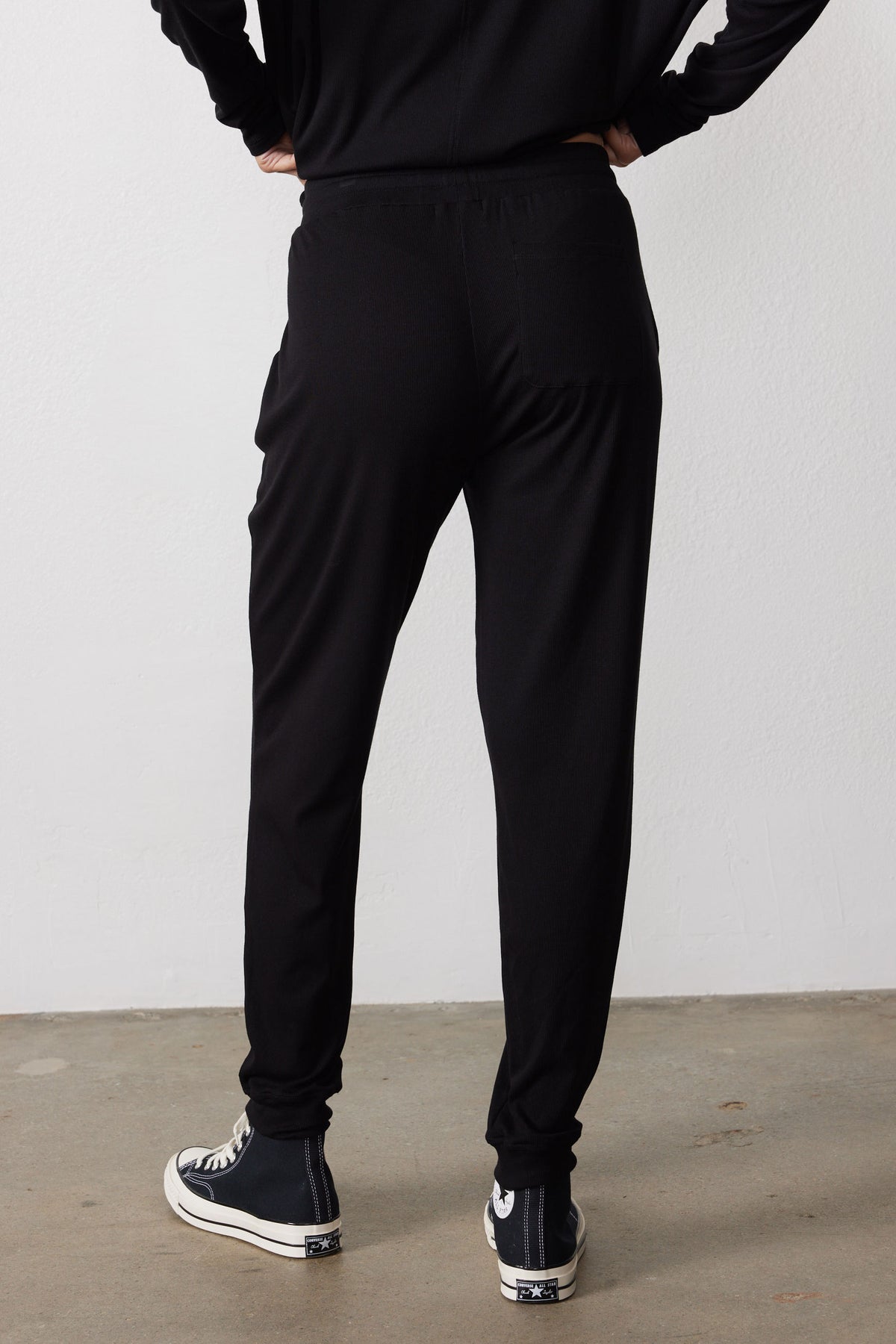 Back view of the black pajama pants with tapered legs