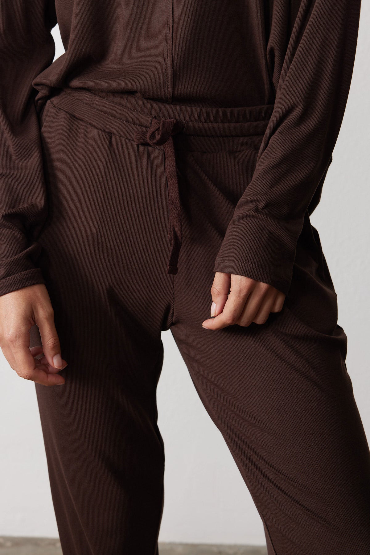 Close-up of the chocolate pajama pants' drawstring waist and front rise