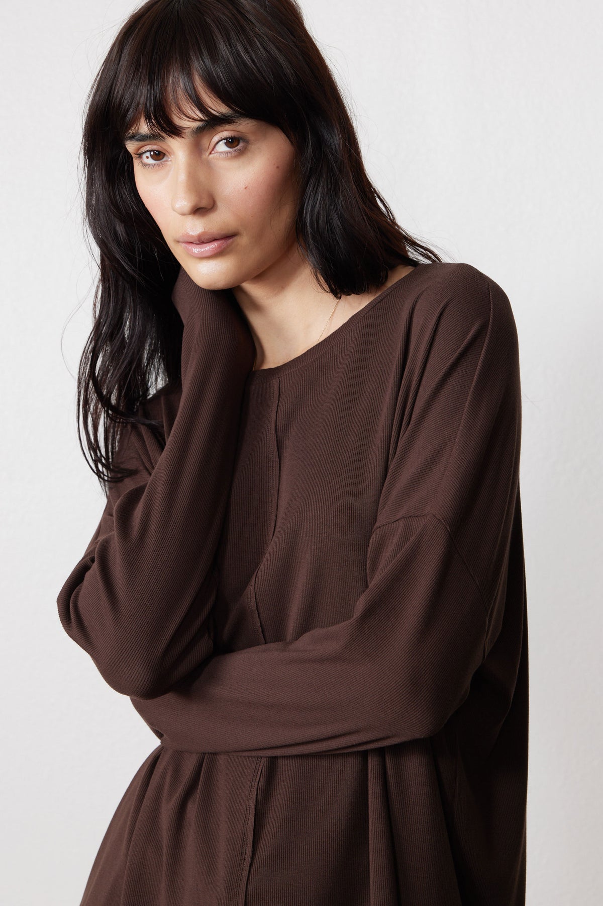 Close-up of the chocolate pajama top's long sleeve and relaxed neckline
