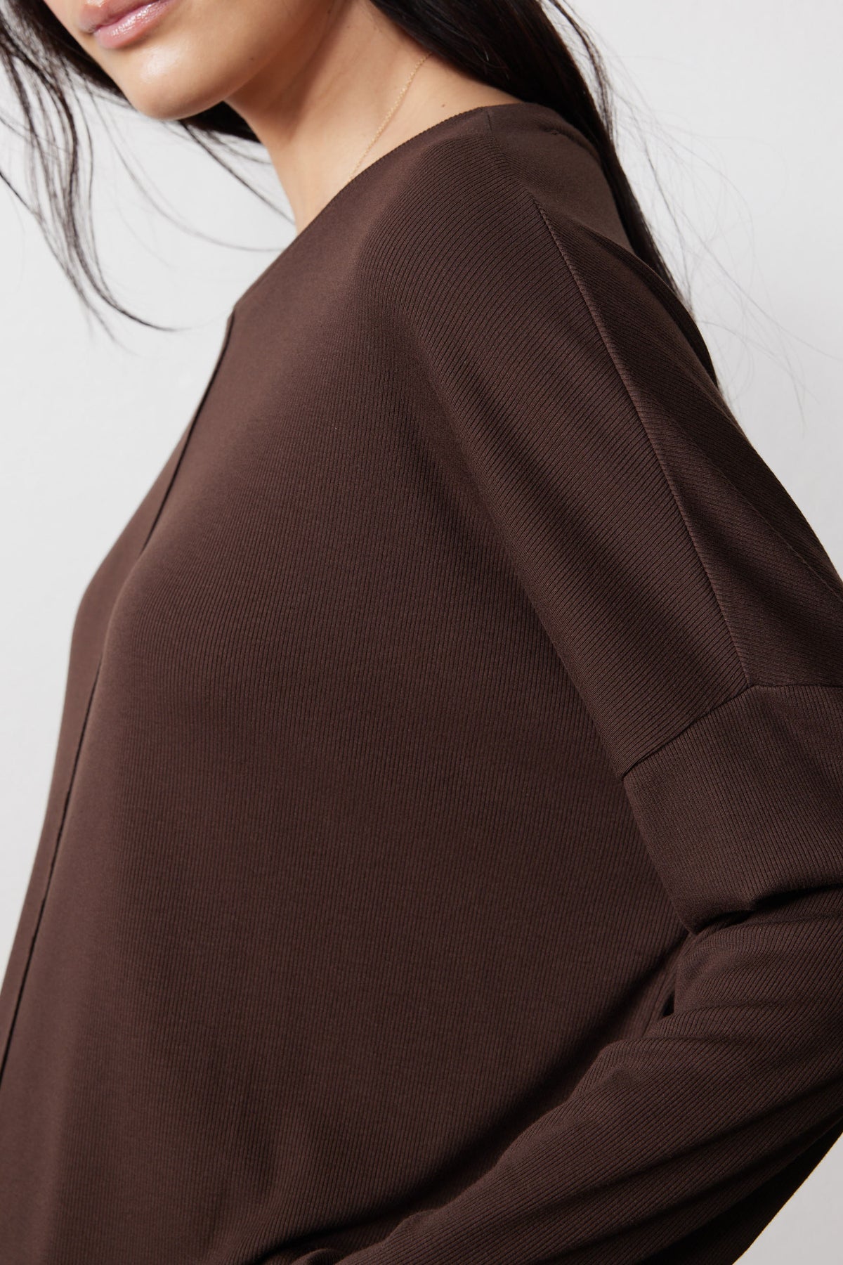 Close-up of the chocolate pajama top's ribbed knit fabric and shoulder seam
