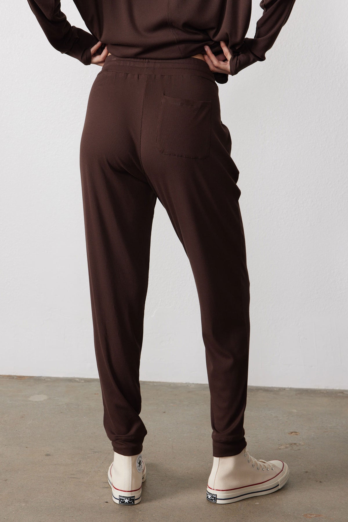 Back view of chocolate pajama pants with a relaxed fit and tapered cuffs