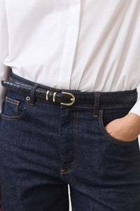 Black croc-embossed belt with gold buckle and leather loop at waist