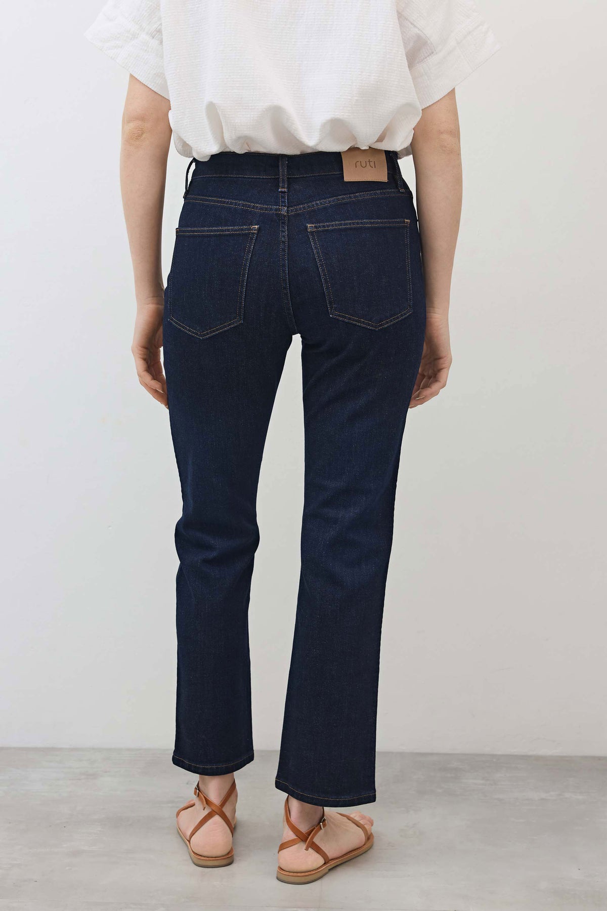 Dark wash mid-rise straight jeans, back yoke, two back pockets and belt loops
