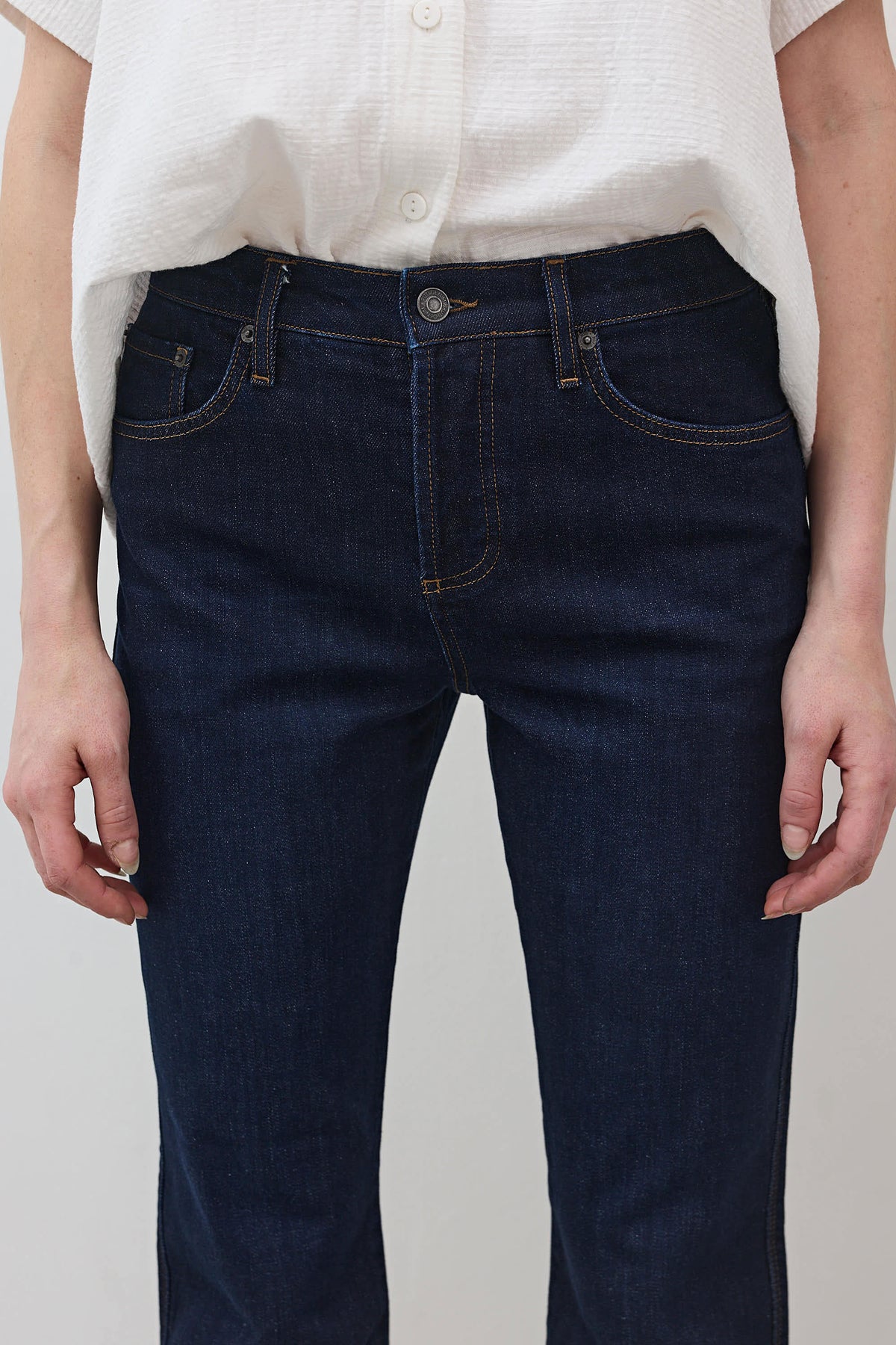 Dark wash mid-rise straight jeans, front button fly, front pockets and belt loops