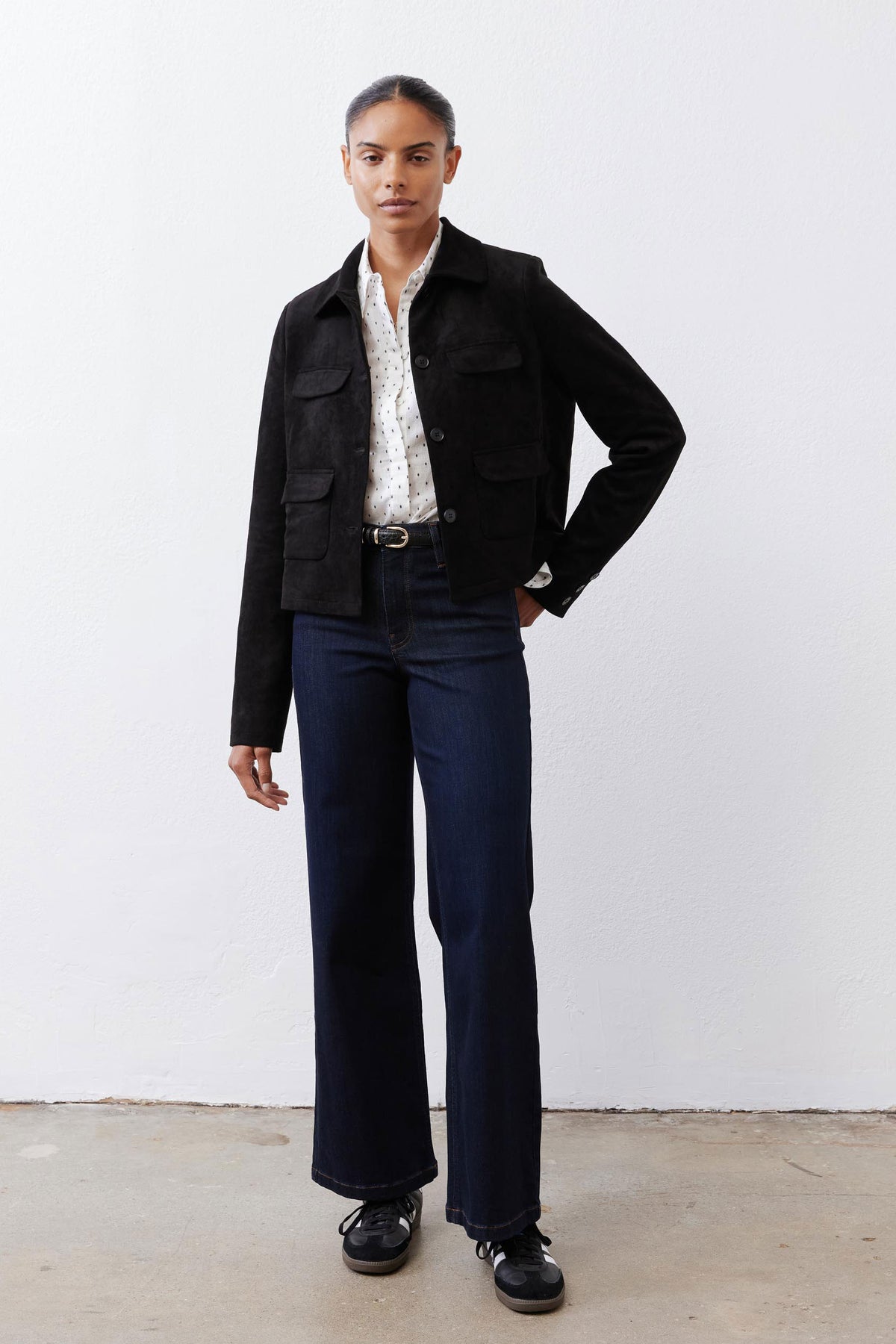 Black cropped suede jacket with button front, flap pockets, and stand collar
