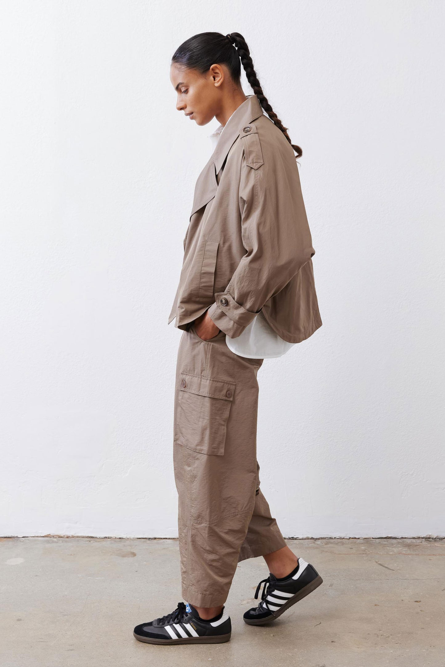 Walnut trench coat side view with point collar and buttoned cuffs