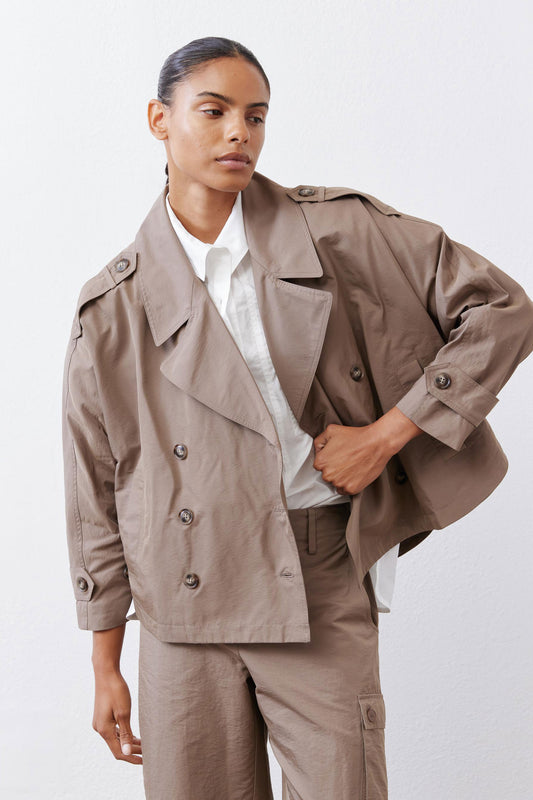 Walnut nylon trench coat close-up: lapels, double buttons, and flap pockets