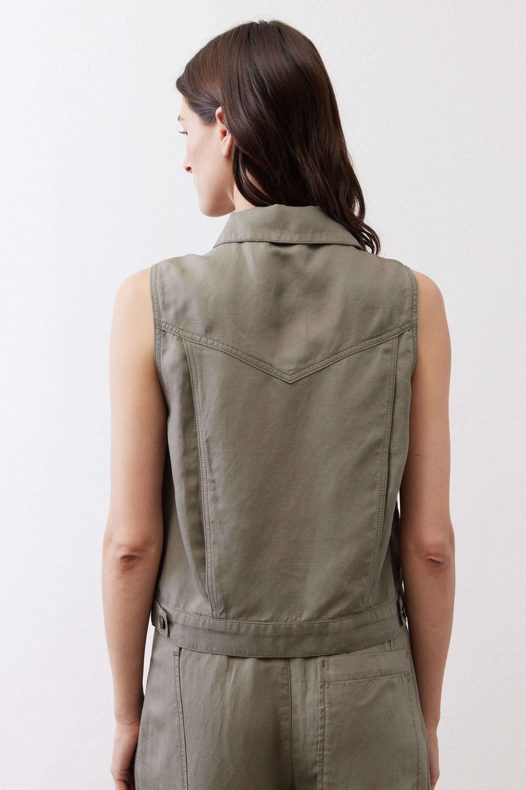 Olive green cropped task vest back view with sleeveless yoke and button placket