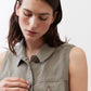 Olive green cropped task vest close-up of buttoned collar and chest patch pocket