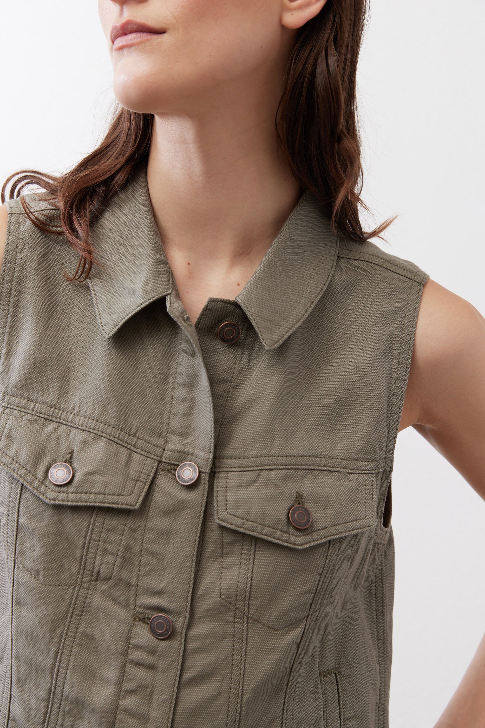 Olive green cropped task vest close-up of collar and chest flap pockets with snaps