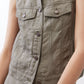 Olive green cropped task vest detail showing patch pockets and button closures