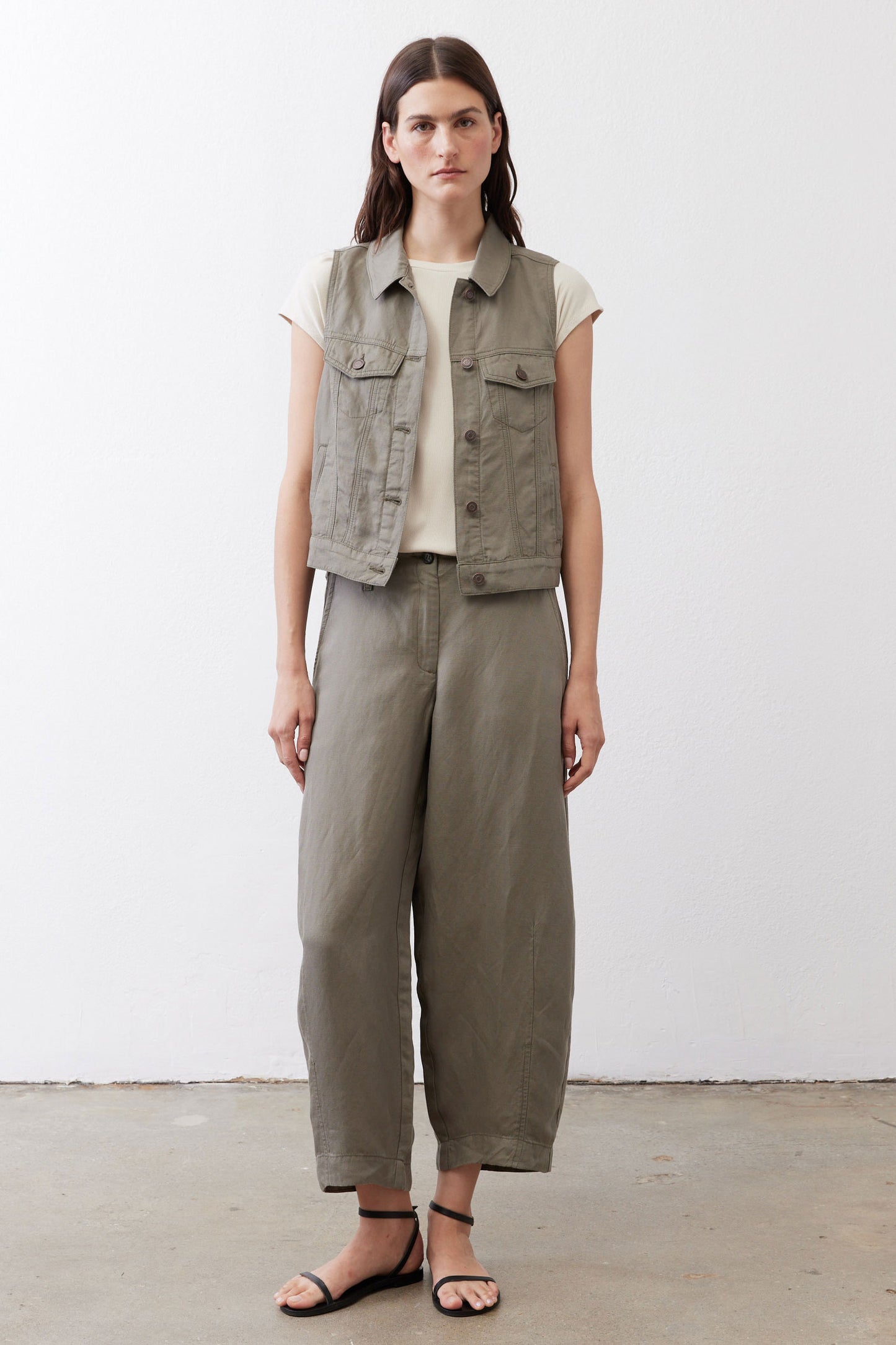 Olive green cropped task vest worn with matching wide-leg pants