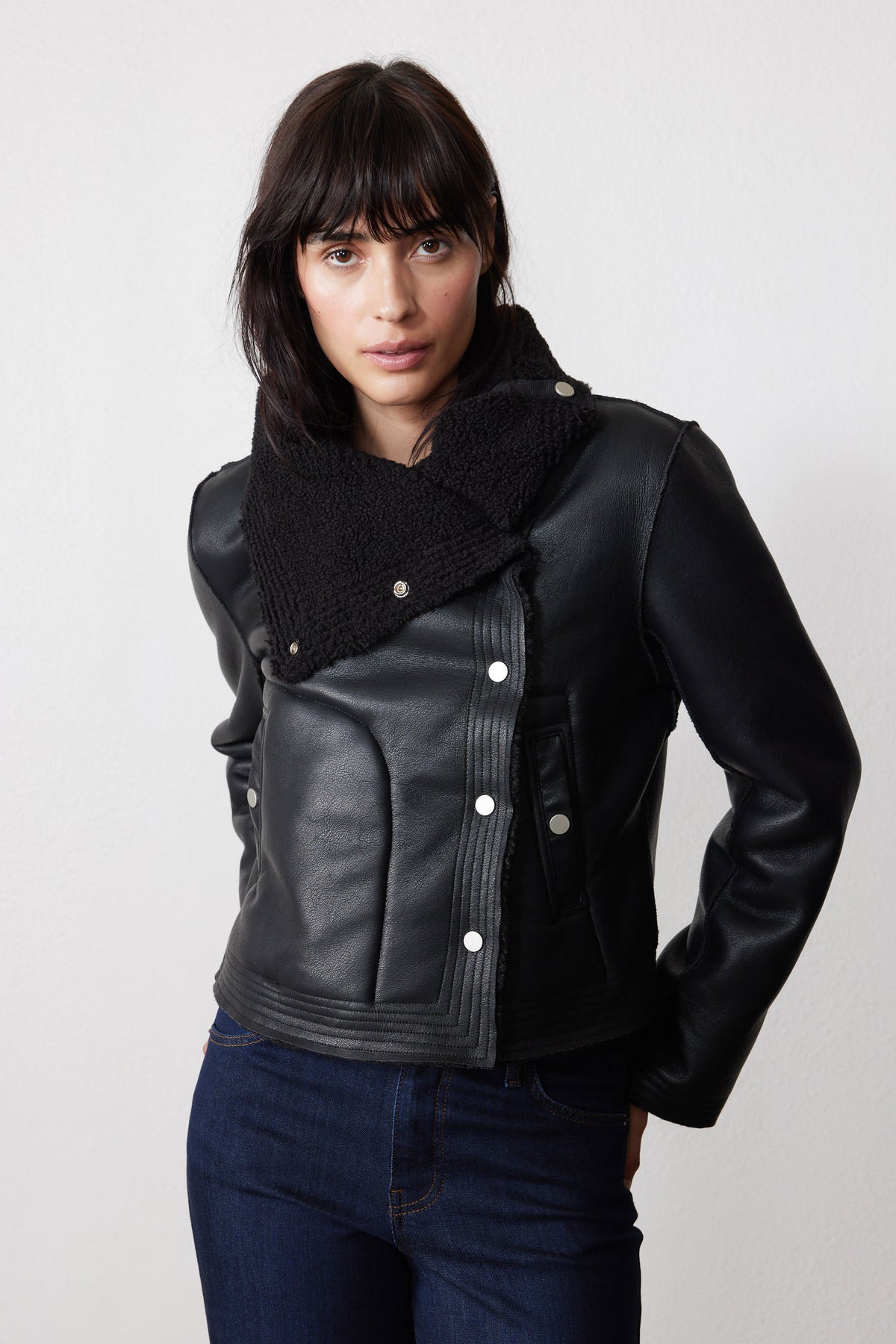 Black reversible moto jacket with asymmetrical snap front and plush shearling lapel