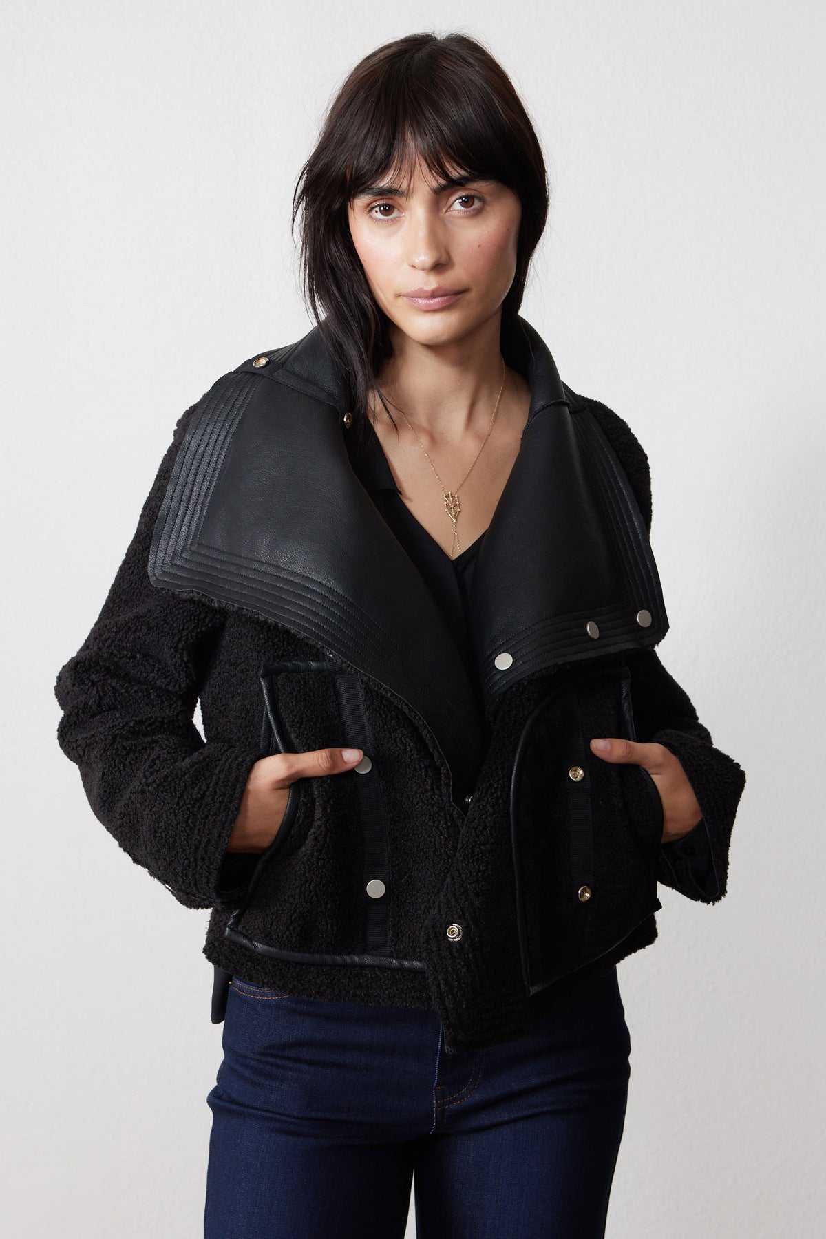Reversed black shearling moto jacket with plush sleeves and leather-look lapels