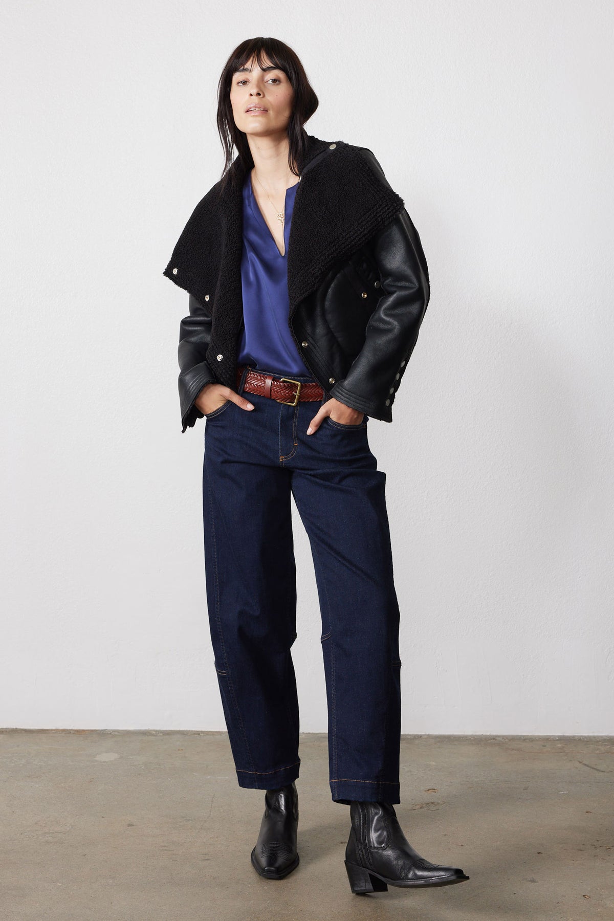 Black reversible shearling moto jacket worn open, showing plush lining and leather-look sleeves