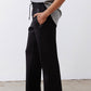 Black scuba pants with elastic drawstring waist and relaxed wide-leg silhouette