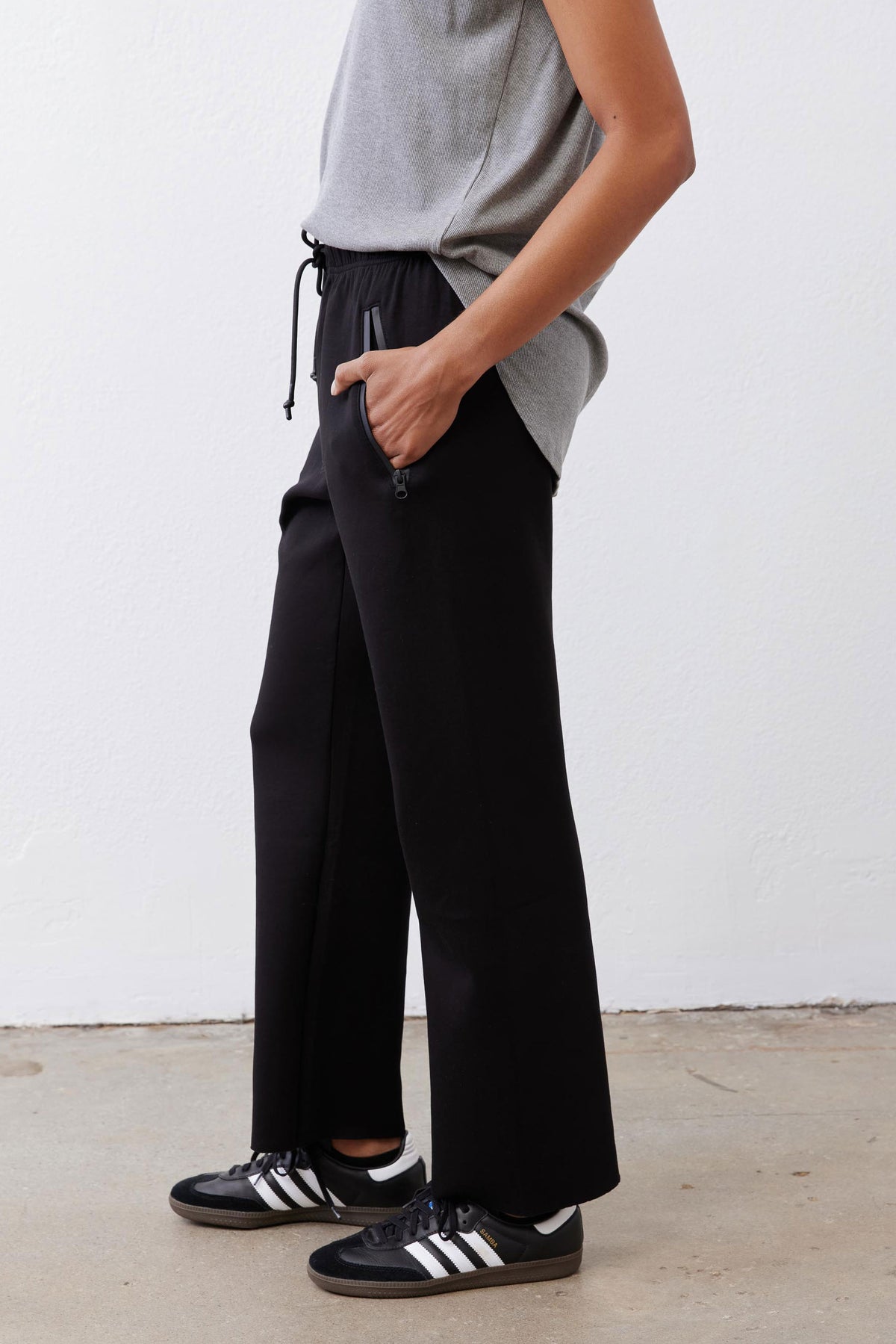 Black scuba pants with elastic drawstring waist and relaxed wide-leg silhouette