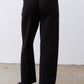Black scuba pants with elastic waistband and draping wide-leg shape