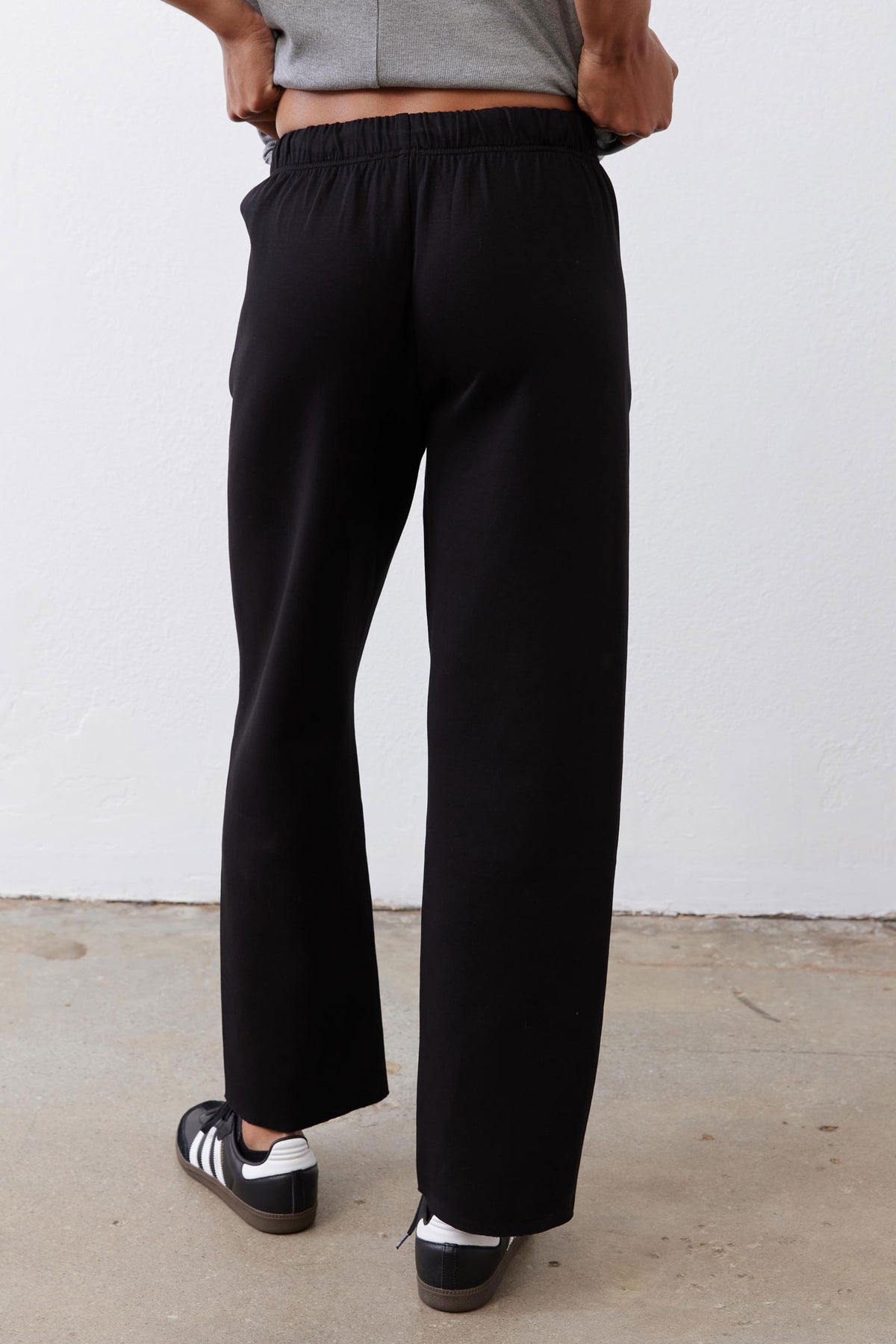 Black scuba pants with elastic waistband and draping wide-leg shape