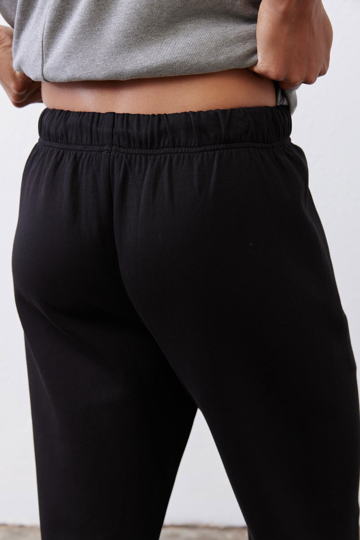 Black scuba pants close-up: elastic waistband with drawstring