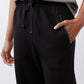 Black scuba pants front view with drawstring tie and elastic waistband