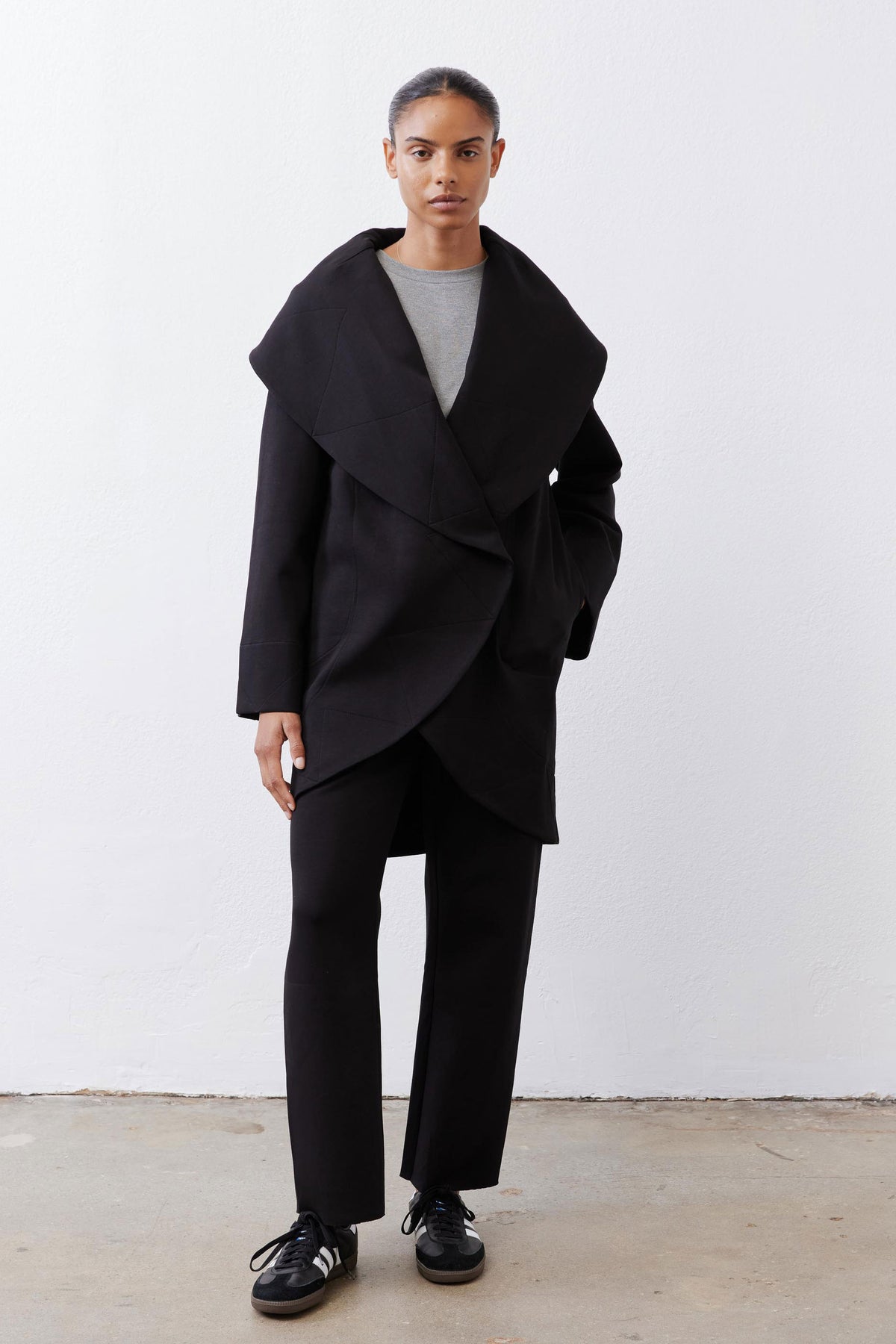 Black scuba pants with relaxed fit, wide legs, and elastic drawstring waist