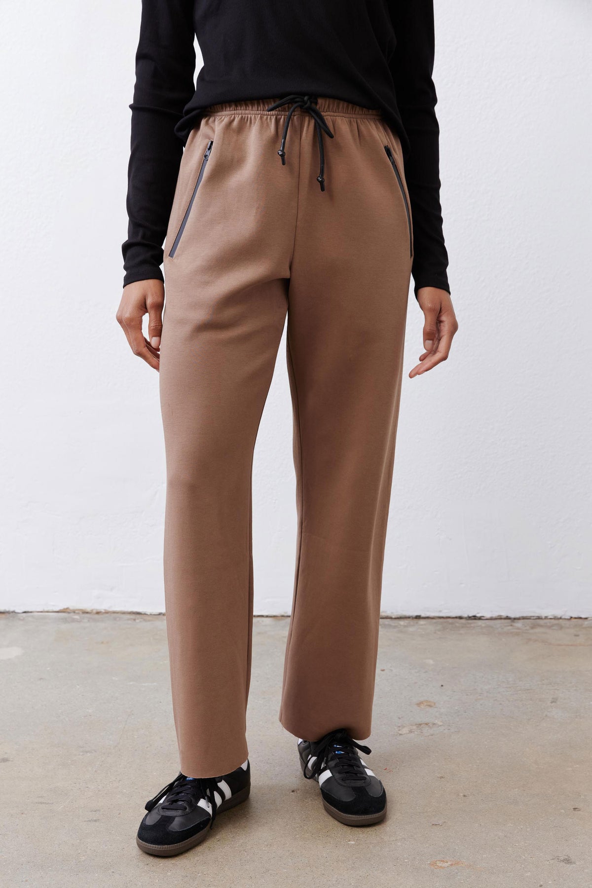 Fawn scuba pants close-up of legs, elastic waist and drawstring with dark accents