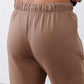 Fawn scuba pants waistband close-up with gathered elastic and smooth fabric