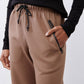 Fawn scuba pants side detail: drawstring waist and angled dark pocket trim