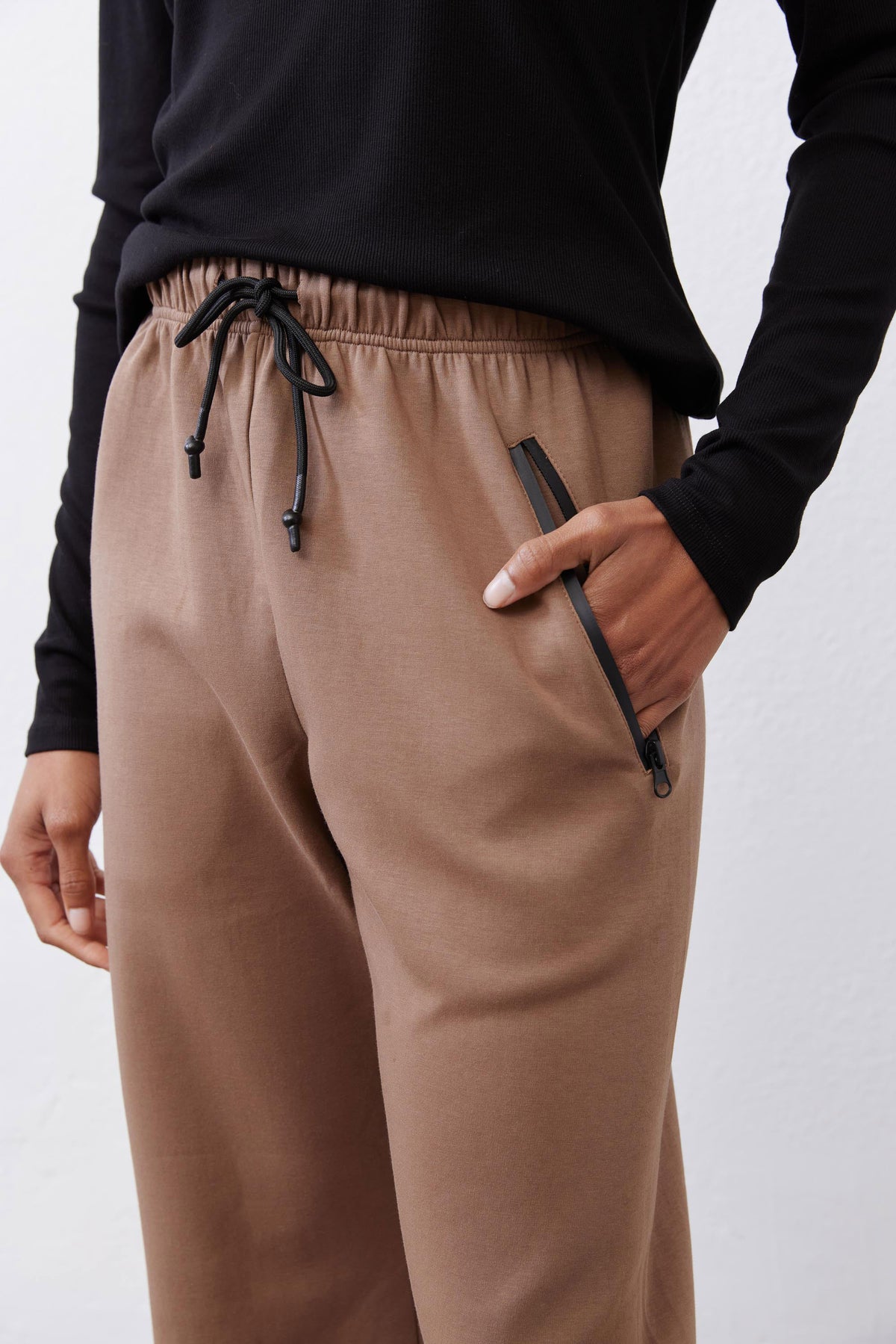 Fawn scuba pants side detail: drawstring waist and angled dark pocket trim