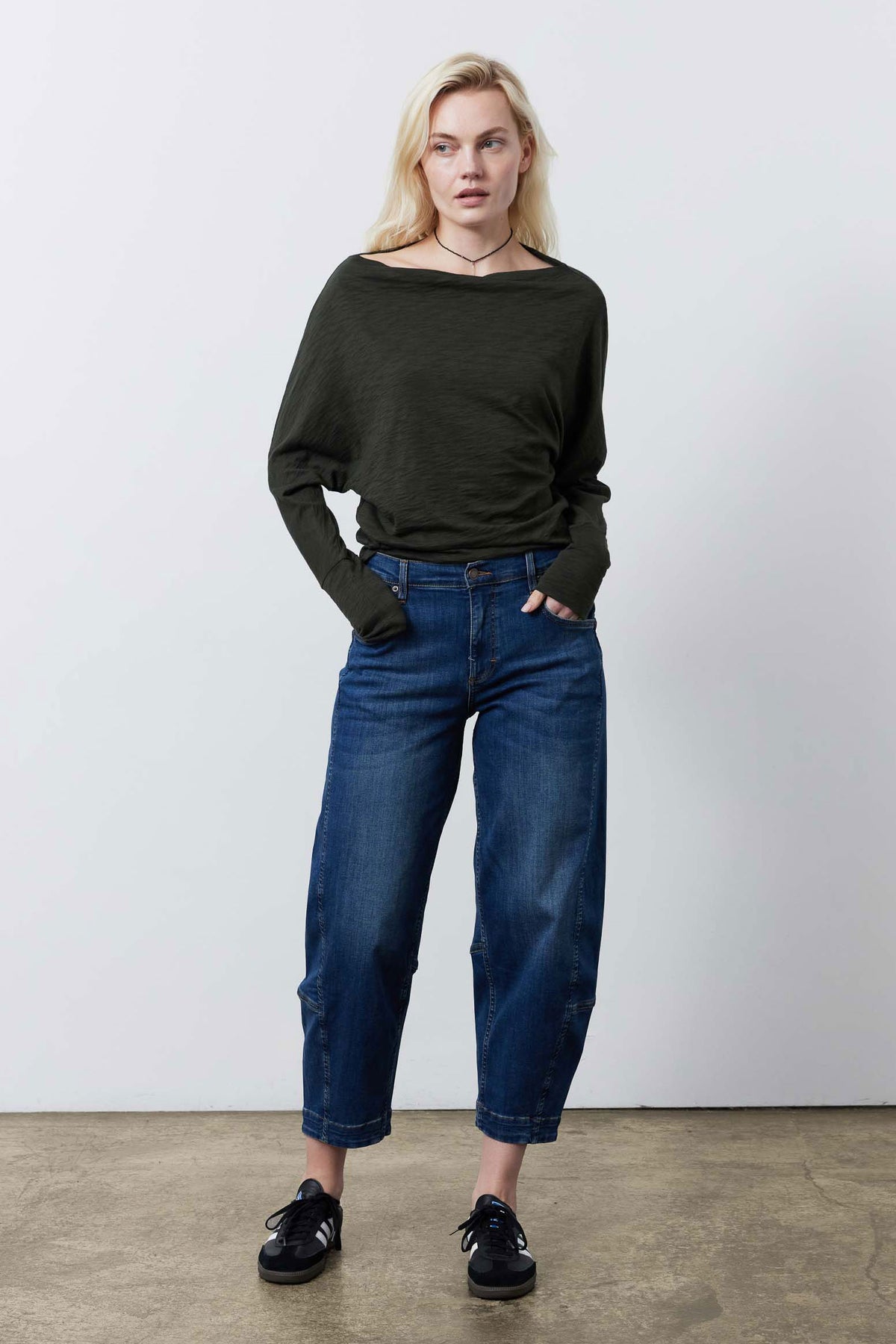 Forest green dolman top worn with blue capri jeans, relaxed fit