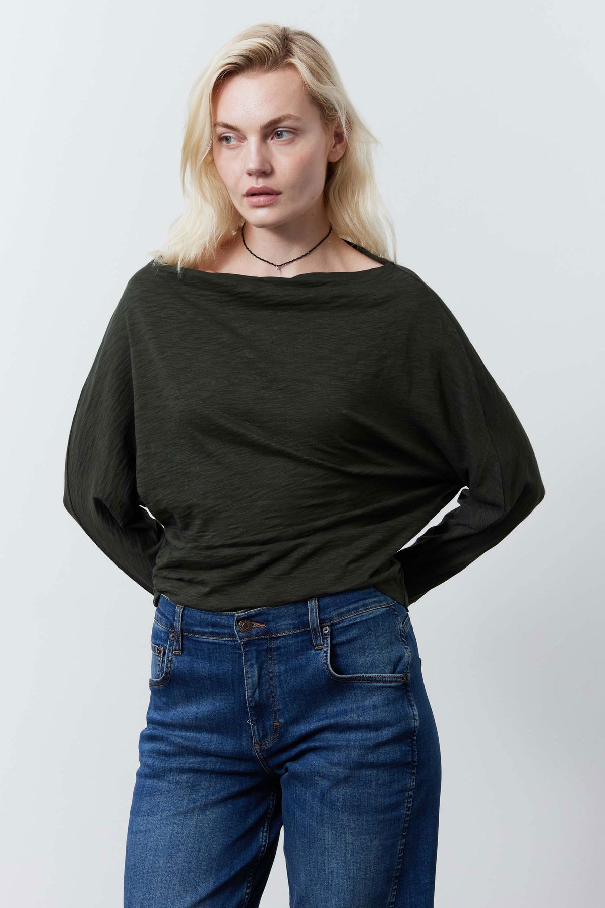 Dark green dolman top with wide sleeves and draped, relaxed body