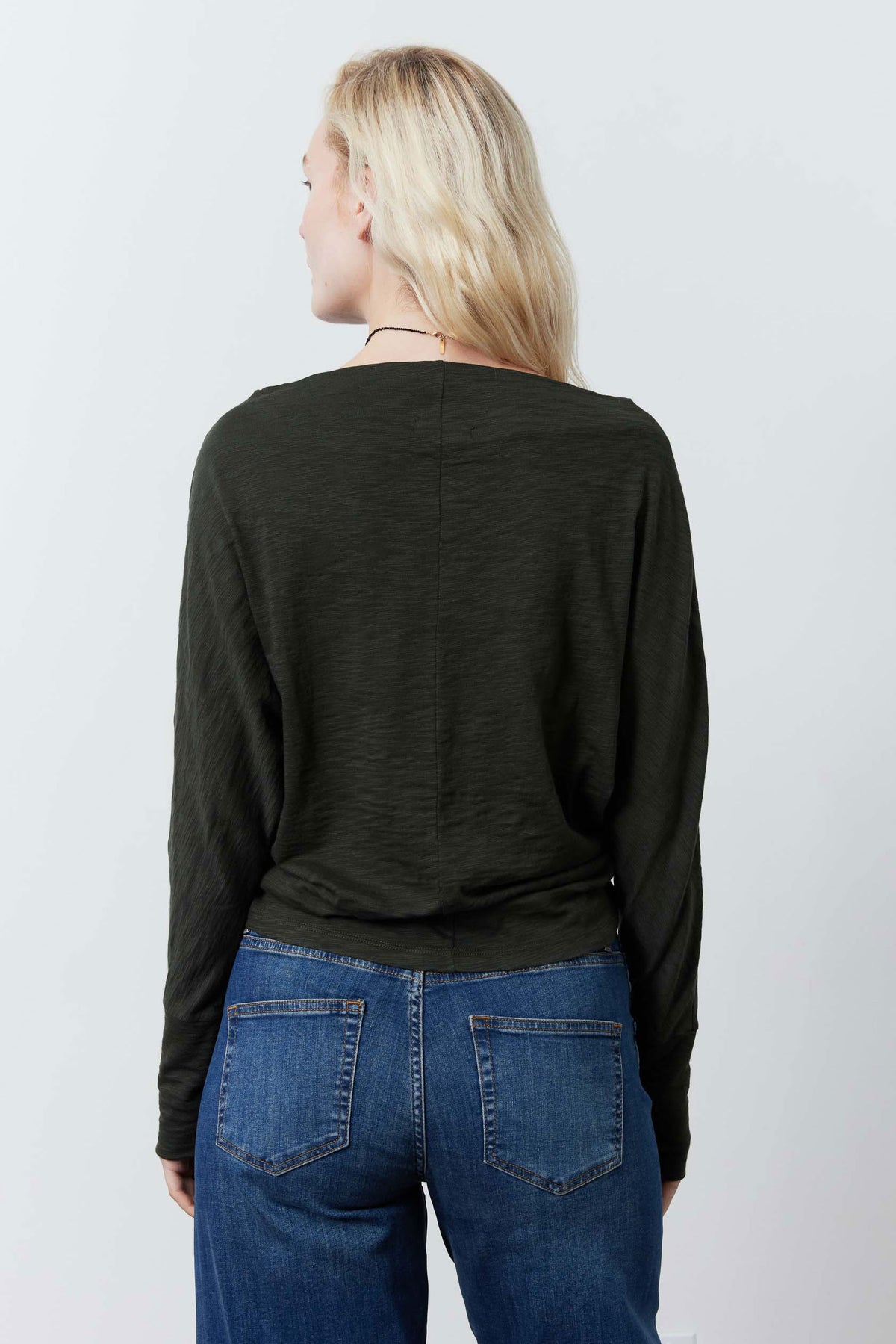 Forest green dolman top back view with relaxed long sleeves
