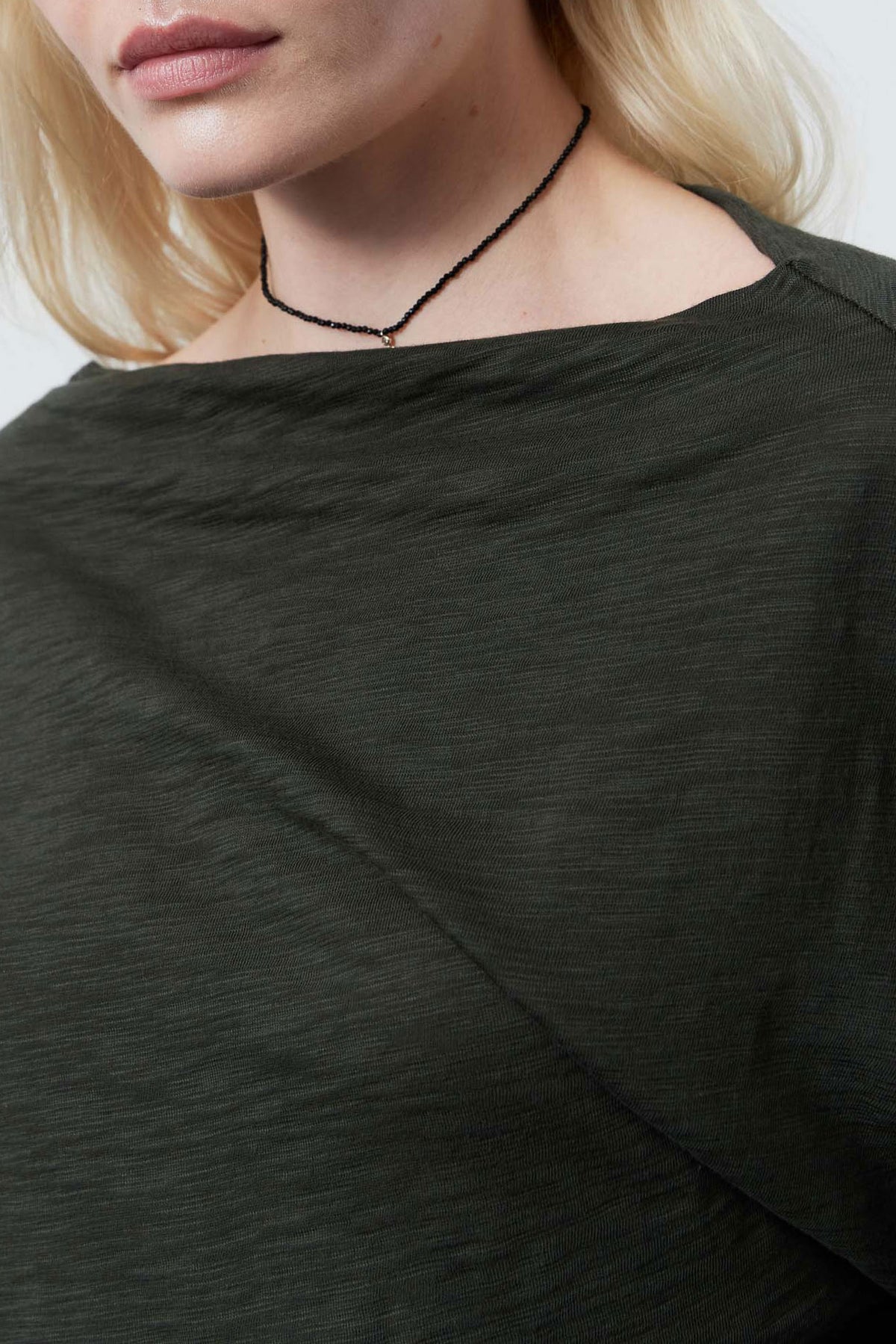 Forest green dolman top with wide neck and draped front