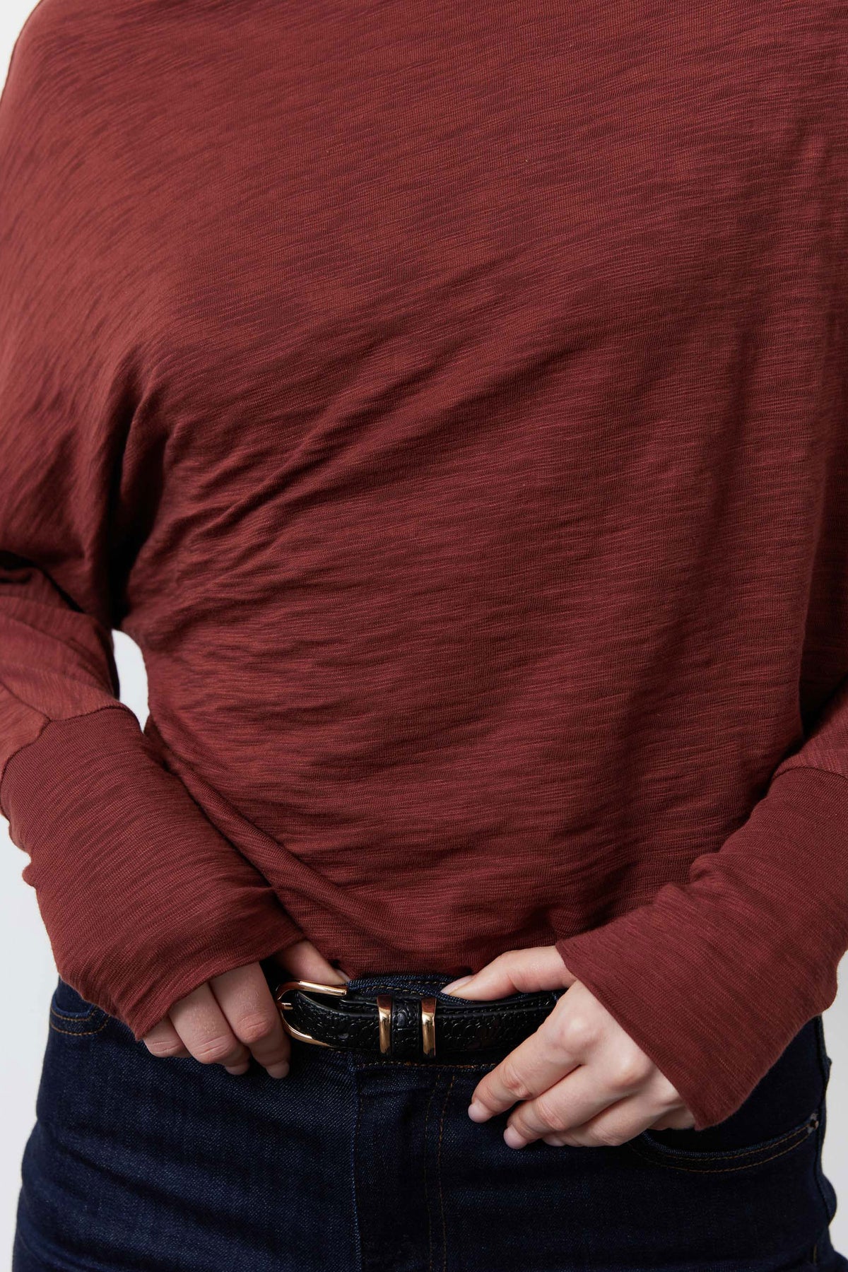 Reddish-brown dolman top sleeve detail with side drape and cuffed hem