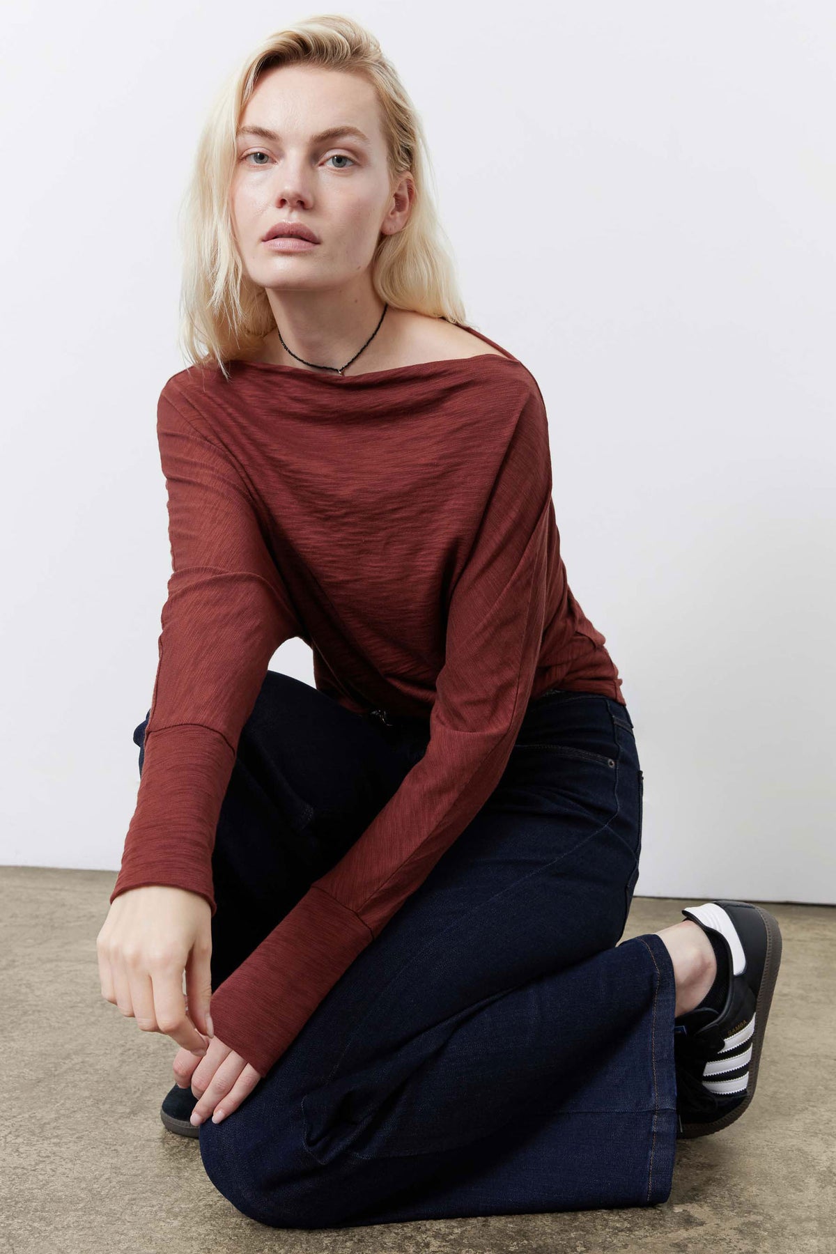 Reddish-brown dolman top with long sleeves and relaxed crew neckline